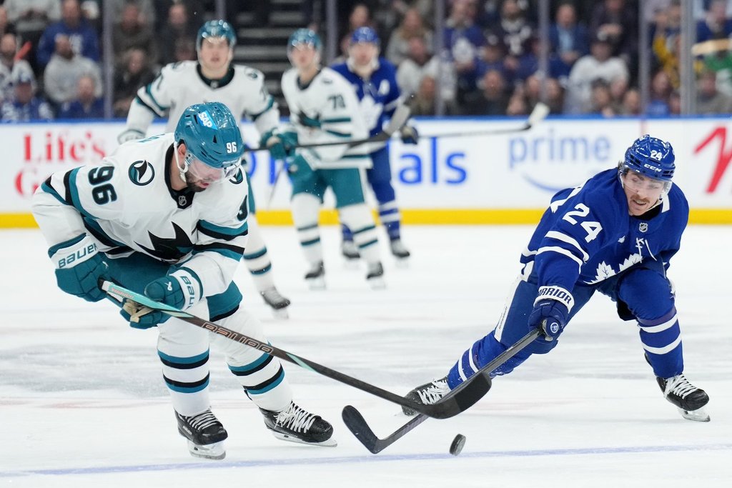 San Jose Sharks defenceman Jake Walman (96) and Toronto Maple Leafs forward Connor Dewar (24) vie for control of the puck during second period NHL hockey action in Toronto, Monday, March 3, 2025.