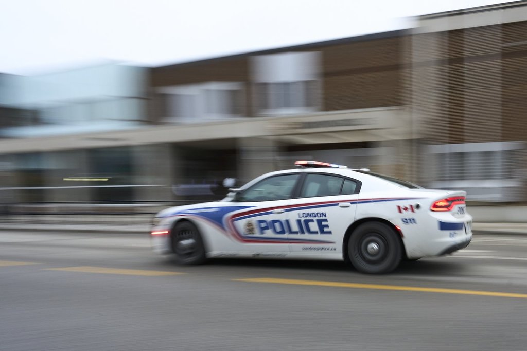 A police car drives by London police headquarters in London, Ont., Monday, Jan. 29, 2024.