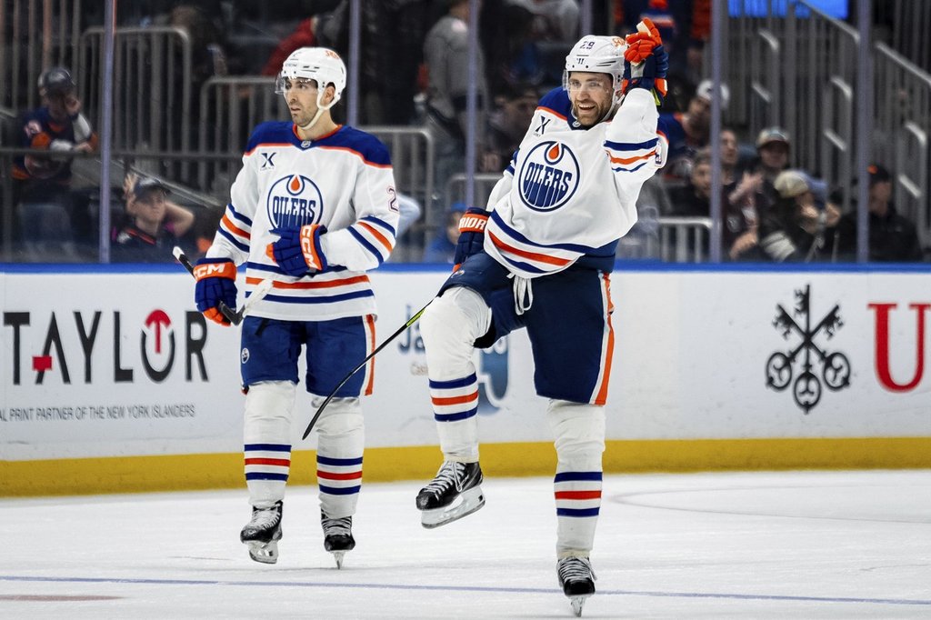 Edmonton Oilers center Leon Draisaitl (29) celebrates scoring the winning goal in overtime of an NHL hockey game against the New York Islanders, Friday, March 14, 2025, in Elmont, N.Y. (AP Photo/Angelina Katsanis).