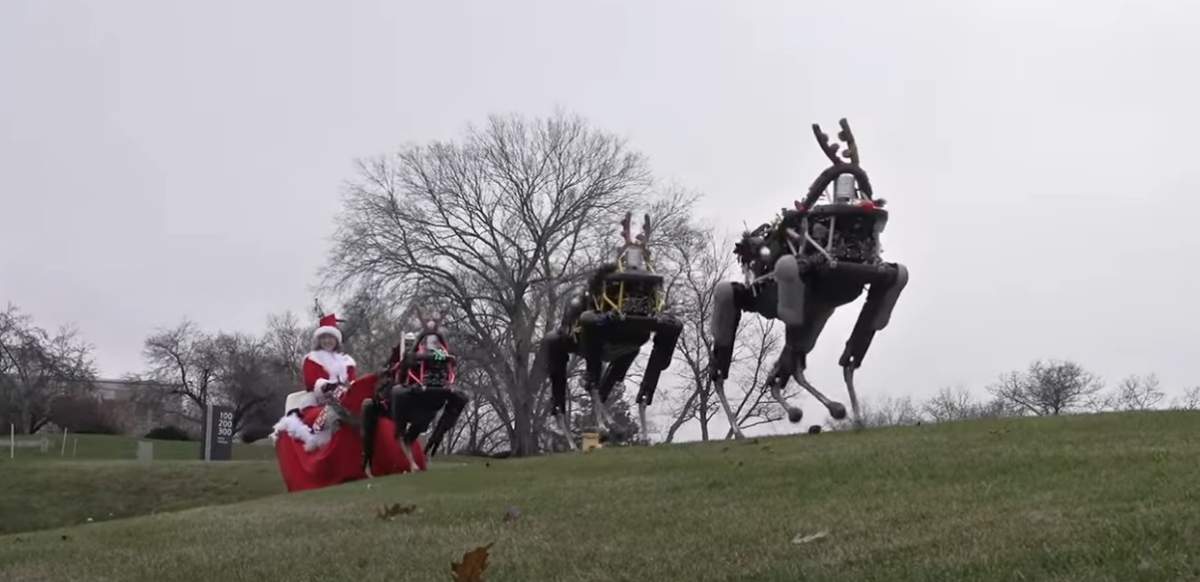 A screenshot of Boston Dynamics robots pulling Santa’s sleigh in a holiday video.