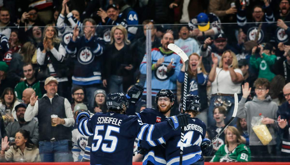 Winnipeg Jets' Mark Scheifele (55), Kyle Connor (81), and Josh Morrissey (44) celebrate Connor's goal against the Dallas Stars during second period NHL action in Winnipeg on Friday, March 14, 2025. THE CANADIAN PRESS/John Woods.