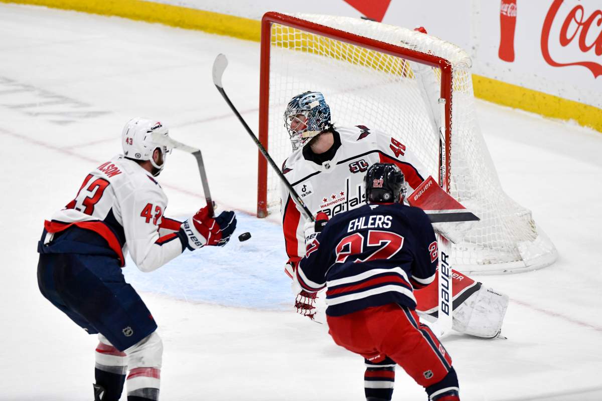 Winnipeg Jets' Nikolaj Ehlers (27) scores the game-winning goal in overtime against Washington Capitals goaltender Logan Thompson (48) during their NHL hockey game in Winnipeg, Tuesday March 25 2025. THE CANADIAN PRESS/Fred Greenslade.