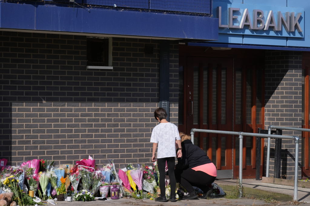 A person lays flowers at Leabank, Luton, Bedfordshire, where Juliana Prosper, 48, Kyle Prosper, 16, and Giselle Prosper, 13, were found dead in a flat in Leabank, off Wauluds Bank Drive. (Photo by Jacob King/PA Images via Getty Images)