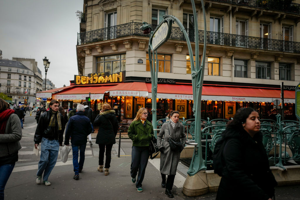 People walk past a Metro entrance in central Paris, France, on December 16, 2024. (Photo by Alberto Pezzali/NurPhoto via Getty Images)