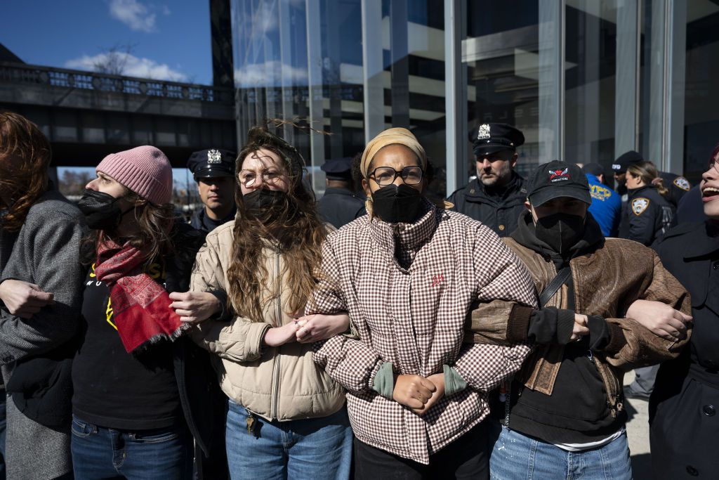 People take part in a 'TeslaTakedown' protest against Elon Musk outside a Tesla car dealership in New York City, United States on 8 March 2025. (Photo by Mostafa Bassim/Anadolu via Getty Images)