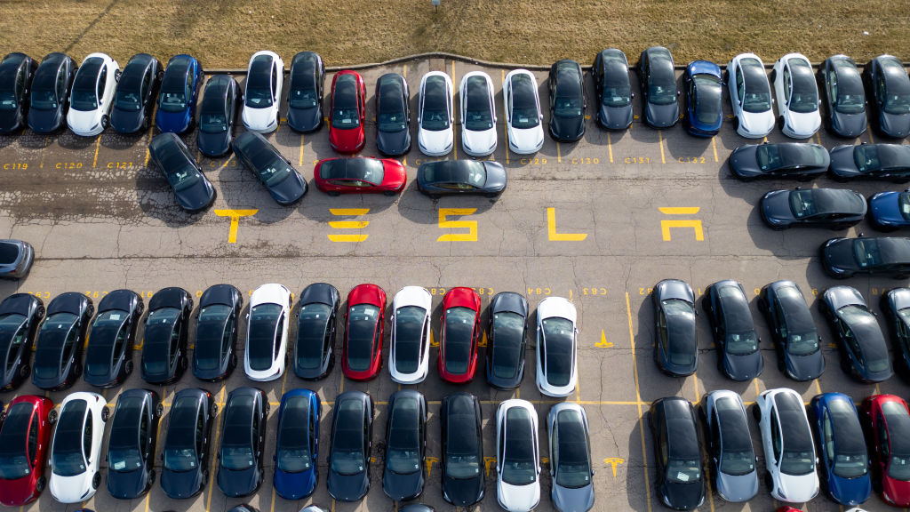 An aerial view of Tesla vehicles sitting in a parking lot on March 20, 2025 in Hamilton, Canada. 80 Teslas were damaged at the Hamilton dealership, making it the largest car vandalism reported in Canada against the U.S. company. (Photo by Katherine KY Cheng/Getty Images