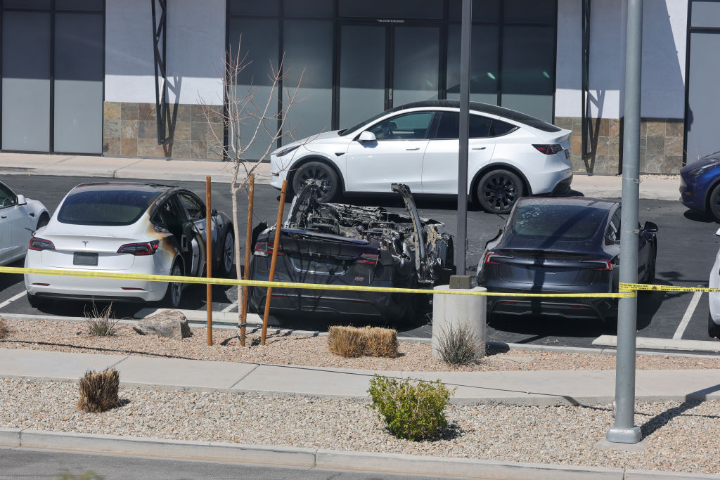 Burned Teslas are shown at a Tesla Collision Center after an individual used incendiary devices to set several vehicles on fire on March 18, 2025 in Las Vegas, Nevada. The Las Vegas Metropolitan Police Department said that five Teslas were damaged and believe that the suspect fired three rounds from a firearm at the vehicles and spray painted the word "RESIST" on the entrance. (Photo by Ethan Miller/Getty Images)