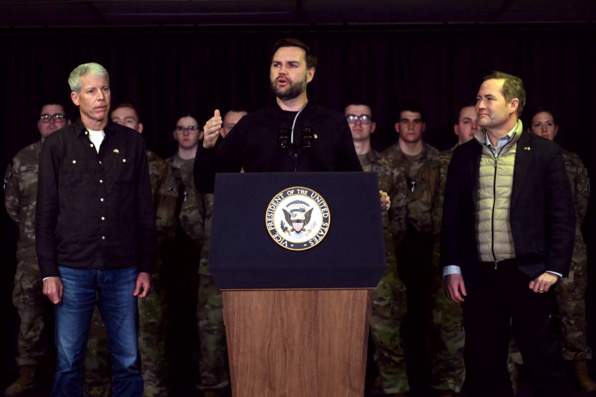 US Vice President JD Vance (C), with Secretary of Energy Chris Wright (L) and National Security Advisor Mike Waltz (R), speaks at the US military's Pituffik Space Base on March 28, 2025 in Pituffik, Greenland.