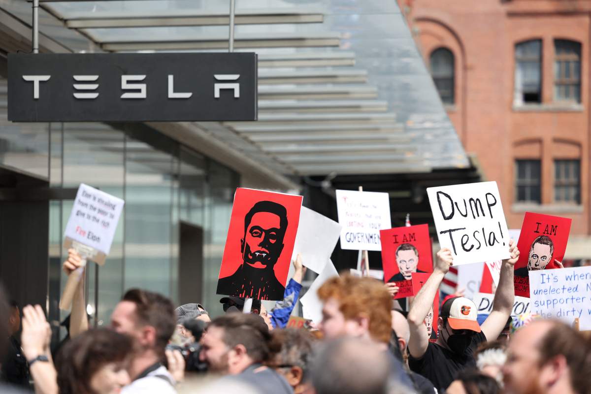Demonstrators rally against Tesla CEO Elon Musk during a "Tesla Takedown" protest outside a Tesla Store in New York on March 29, 2025.