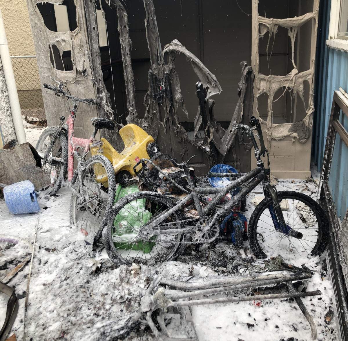 A close up of the damage the fire caused. The picture shows burnt and melted bicycles as well as a burnt backyard storage shed.