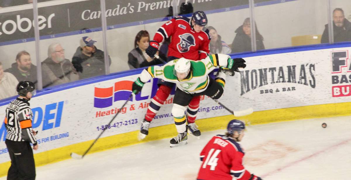 Ryder Boulton of the London Knights takes Jack LaBrash of the Kitchener Rangers into the boards in a game between the Knights and Rangers on Tuesday, March 18, 2025 at the Kitchener Memorial Auditorium.
