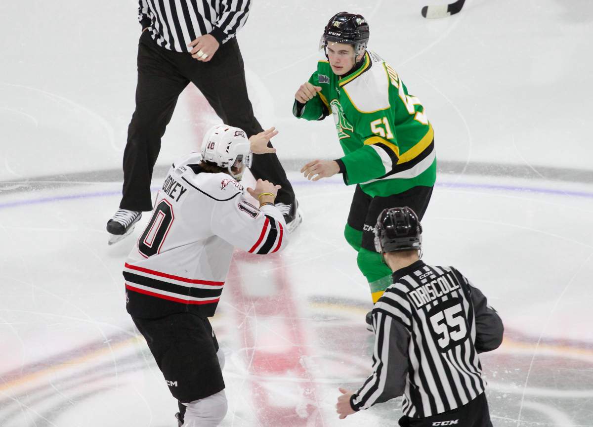 Jared Woolley of the London Knights and Landon Woolley of the Owen Sound Attack eye each other up at centre ice in Game 1 of the Western Conference quarter-final series between the teams played at Canada Life Place on March 28, 2025.