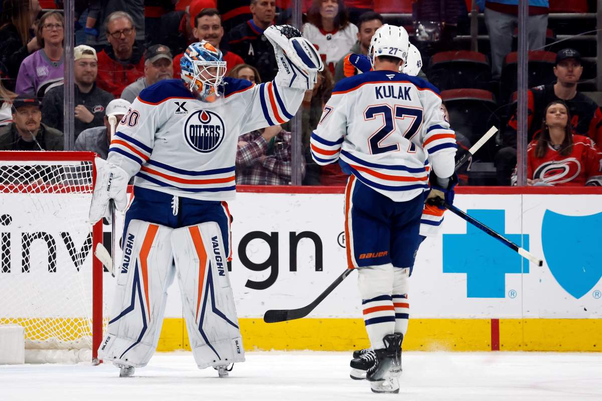 Edmonton Oilers goaltender Calvin Pickard (30) celebrates a win over the Carolina Hurricanes with teammates during the third period of an NHL hockey game in Raleigh, N.C., Saturday, March 1, 2025.