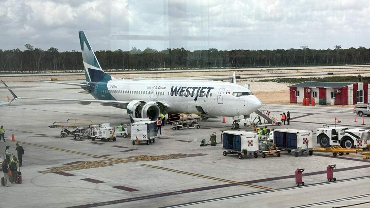 A WestJet plane sitting on the tarmac of the airport in Tulum, Mexico in March 2025.