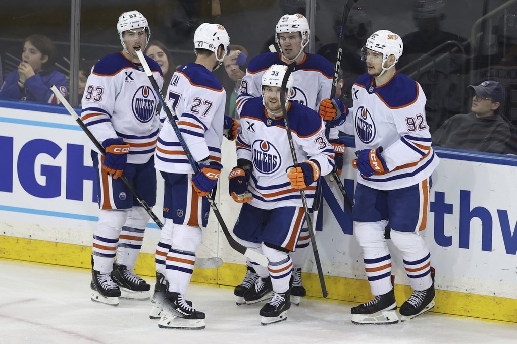 From left, Edmonton Oilers' Ryan Nugent-Hopkins, Brett Kulak, Viktor Arvidsson, Ty Emberson and Vasily Podkolzin react after Arvidsson scored during the third period of an NHL hockey game against the New York Rangers Sunday, March 16, 2025, in New York. (AP Photo/Pamela Smith).