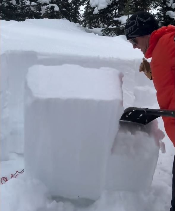 Mountain Rescue Specialist, Mike Koppang, of Kananaskis Mountain Rescue shows how there is a weak layer of snow, up to a metre below the surface.