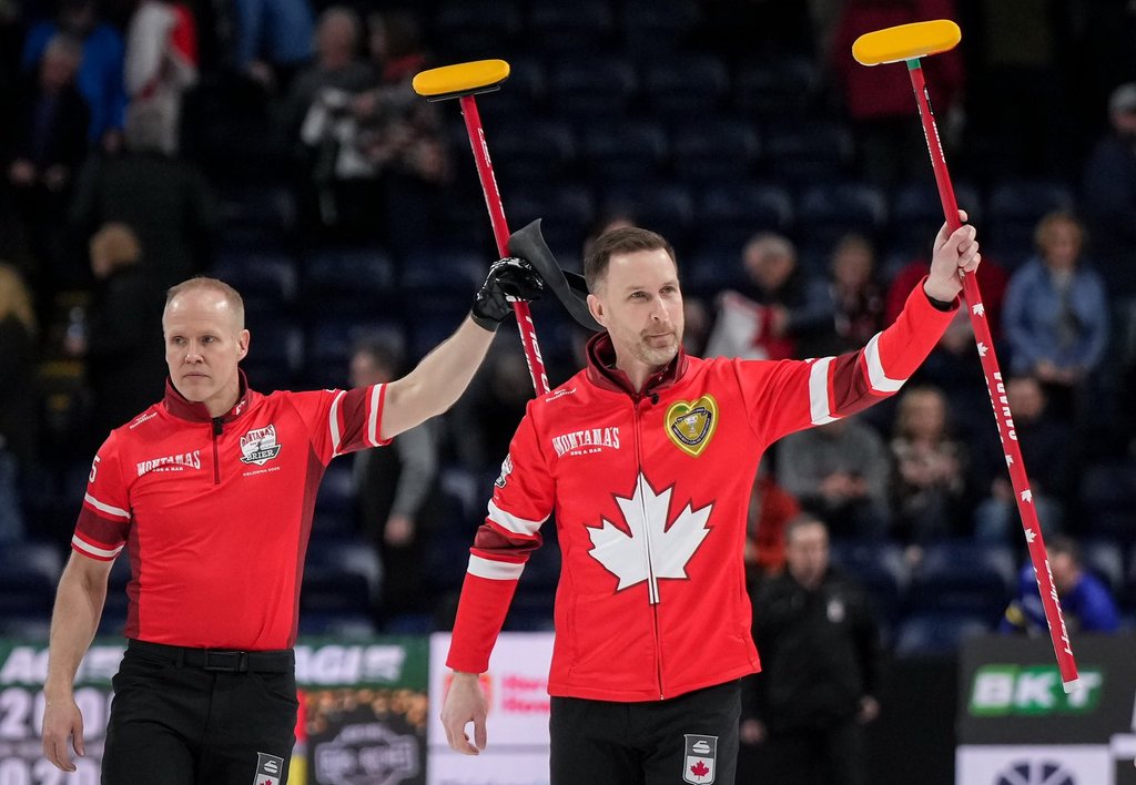 Canada skip Brad Gushue, front right, and third Mark Nichols celebrate after defeating Alberta-Jacobs during the playoffs at the Brier, in Kelowna, B.C., on Friday, March 7, 2025. THE CANADIAN PRESS/Darryl Dyck.
