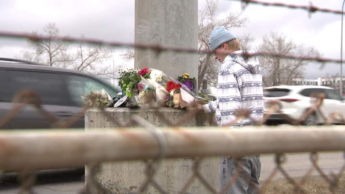 Mourners continue to drop off flowers and pay their respects at the site of a firey crash on Crowchild Trail S.W. in Calgary that resulted in the death of a 16-year-old boy.