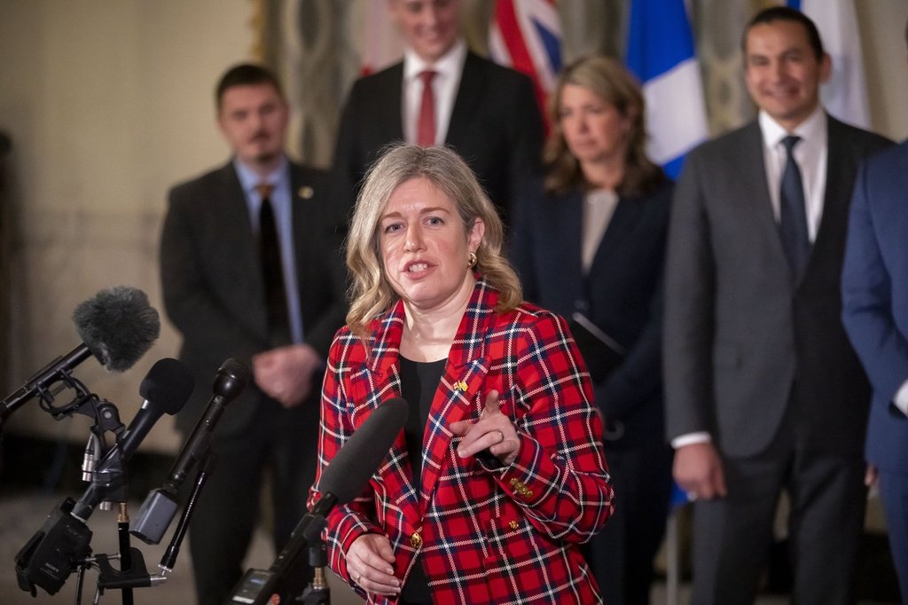Premier of New Brunswick Susan Holt, accompanied by other Council of the Federation members, speaks to reporters at the Mayflower Hotel in Washington, Wednesday, Feb. 12, 2025. 