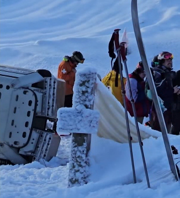 A car from the Golden Eagle Express gondola is seen lying on the ground with rescue crews and other skiiers gathered around after the car became detatched and fell to the ground early Monday morning.