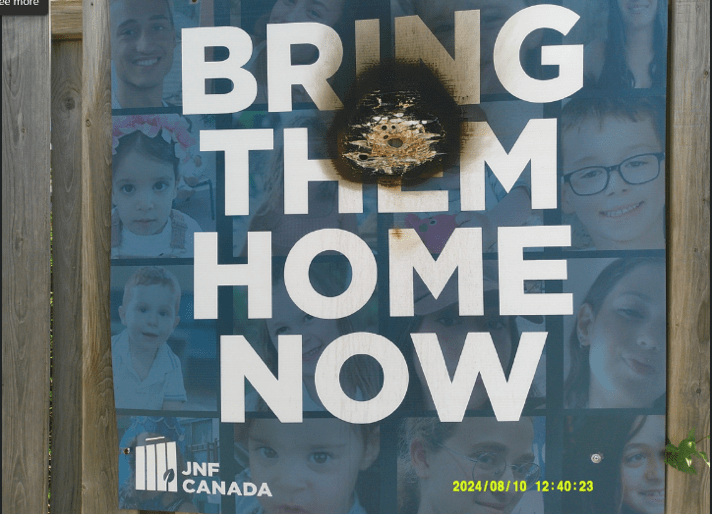 A sign outside Toronto's Tiferet Israel Congregation showing photos of children held hostage by Hamas was allegedly torched by Amir Arvahi Azar on Aug. 3, 2024.
