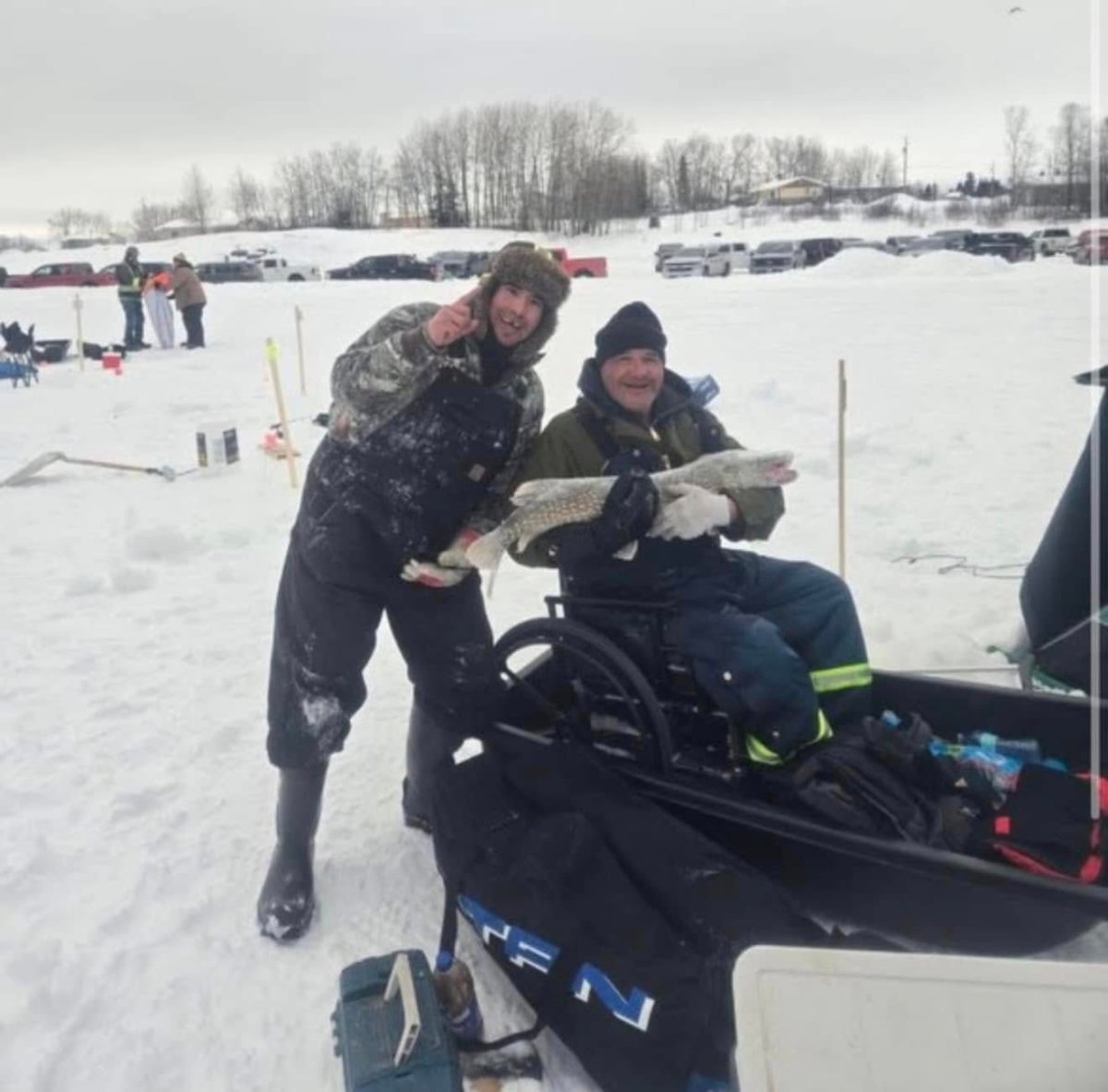 Theodore Muskego seen here with his 100-centimetre pike and his dad, Glenn. The catch earned him $100,000 in a Cross Lake icefishing derby on March 2.