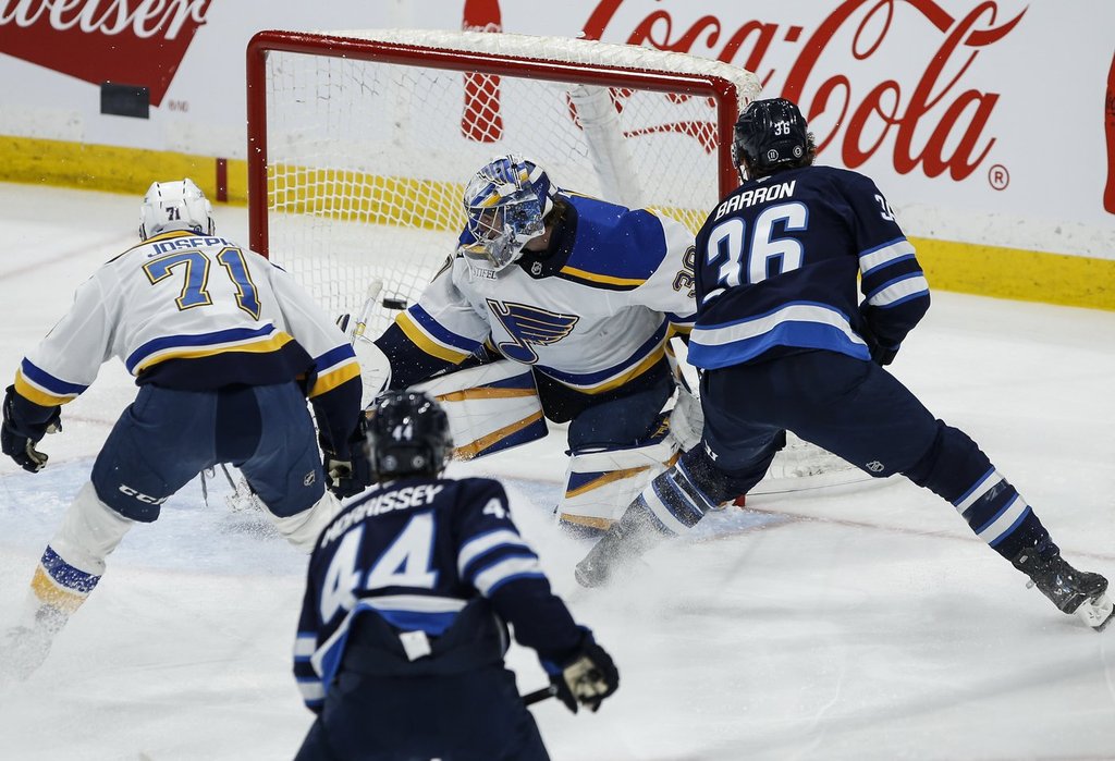 Winnipeg Jets' Morgan Barron (36) scores on St. Louis Blues goaltender Joel Hofer (30) during second period NHL action in Winnipeg on Monday, April 7, 2025. THE CANADIAN PRESS/John Woods.