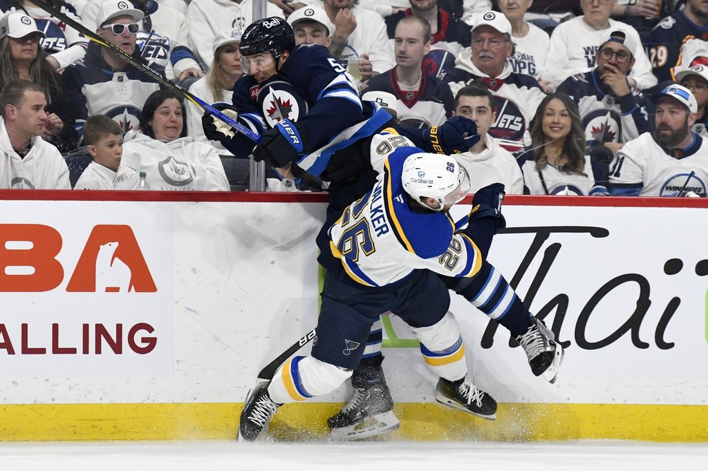 St. Louis Blues' Nathan Walker (26) checks Winnipeg Jets' Luke Schenn (5) during second period NHL playoff action in Winnipeg, Monday April 21, 2025. THE CANADIAN PRESS/Fred Greenslade.