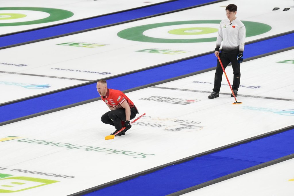 Canada skip Brad Jacobs watches his stone as China's Zhiyu Wang looks on during the bronze-medal game at the BKT World Men's Curling Championship in Moose Jaw, Sask., on Sunday, April 6, 2025.