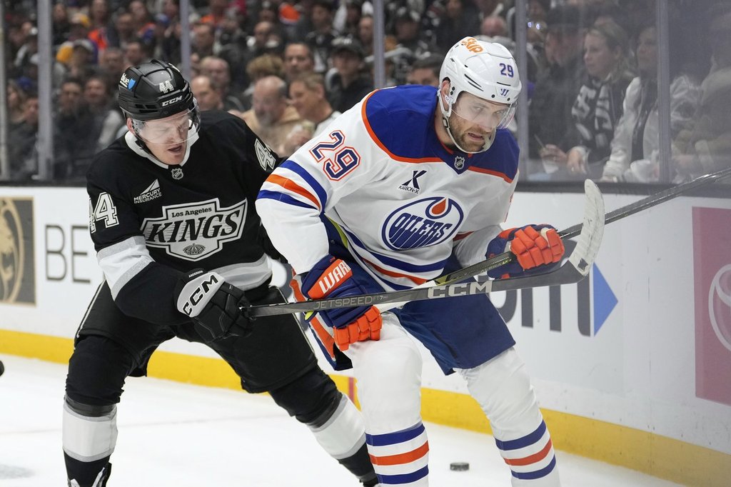 Los Angeles Kings defenceman Mikey Anderson, left, battles with Edmonton Oilers centre Leon Draisaitl during the first period in Game 2 of an NHL hockey first-round playoff series Wednesday, April 23, 2025, in Los Angeles.