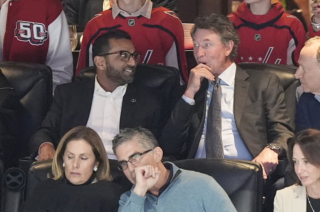 FBI director is Kash Patel, left, tallking with former NHL player Wayne Gretzky, right, during the first period of an NHL hockey game between the Washington Capitals and Chicago Blackhawks, Friday, April 4, 2025, in Washington.