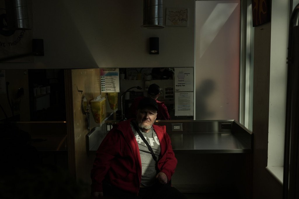 Mike Erickson wheels his power chair around a Toronto supervised consumption site,