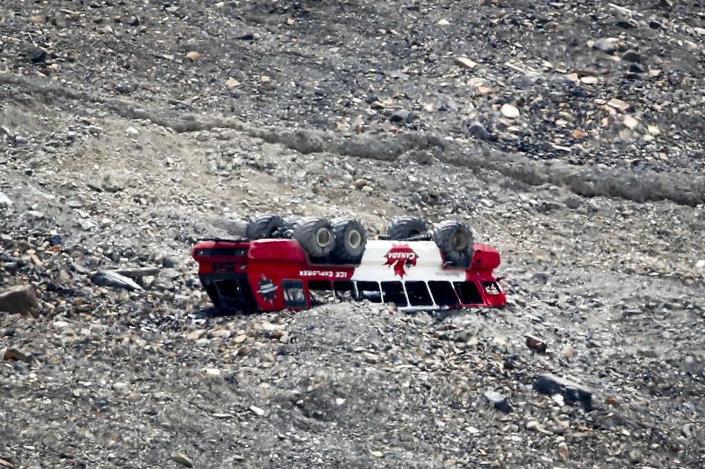 A rolled-over tour bus rests where it fell on the Columbia Icefield near Jasper, Alta., Sunday, July 19, 2020.