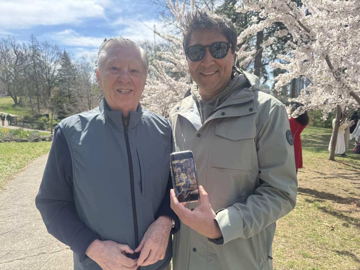 A father and son enjoy peak blooming season for the cherry blossoms at High Park — in honour of their late loved one.