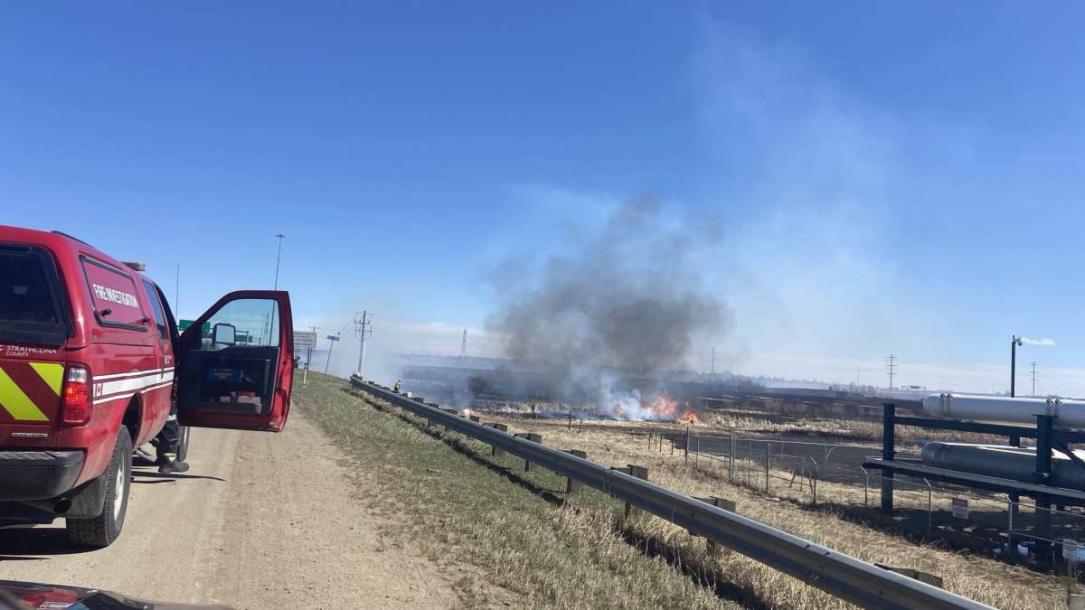 A fire burns near Baseline Road east of Edmonton on April 19, 2025.