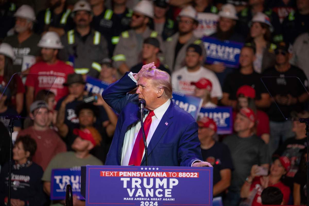 Donald Trump checks out his hair on a large screen during campaign rally at Ed Fry Arena in Indiana, Pa., Monday, Sept. 23, 2024.
