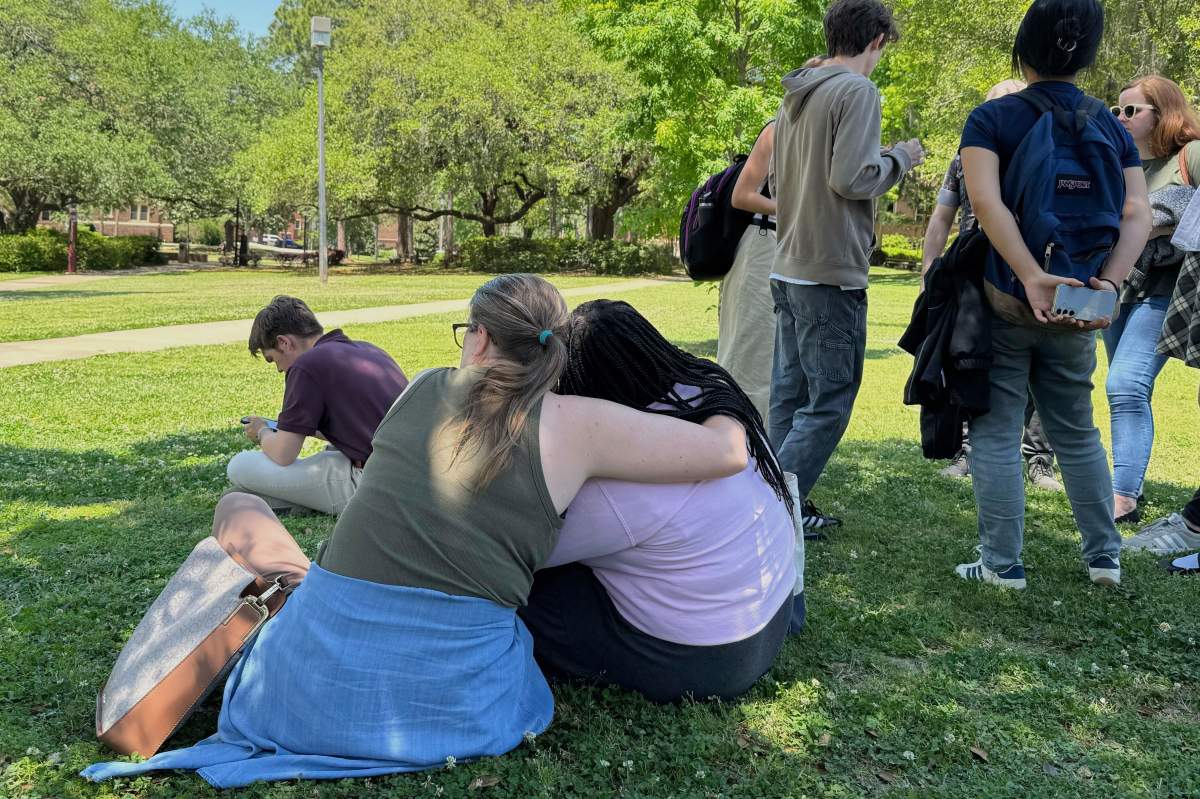 People comfort each other on Florida State University’s campus in Tallahassee, where law enforcement responded to a reported active shooter incident Thursday, April 17, 2025. (AP Photo/Kate Payne)