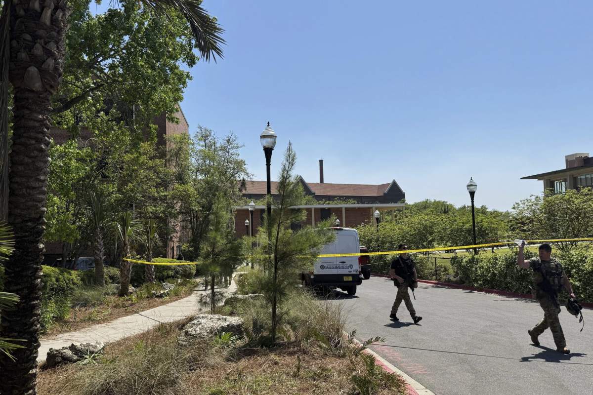 Dozens of patrol vehicles, including a forensics van, are stationed outside of Florida State University’s student union building, the scene of a shooting, Thursday, April 17, 2025, in Tallahassee, Fla. (AP Photo/Kate Payne)