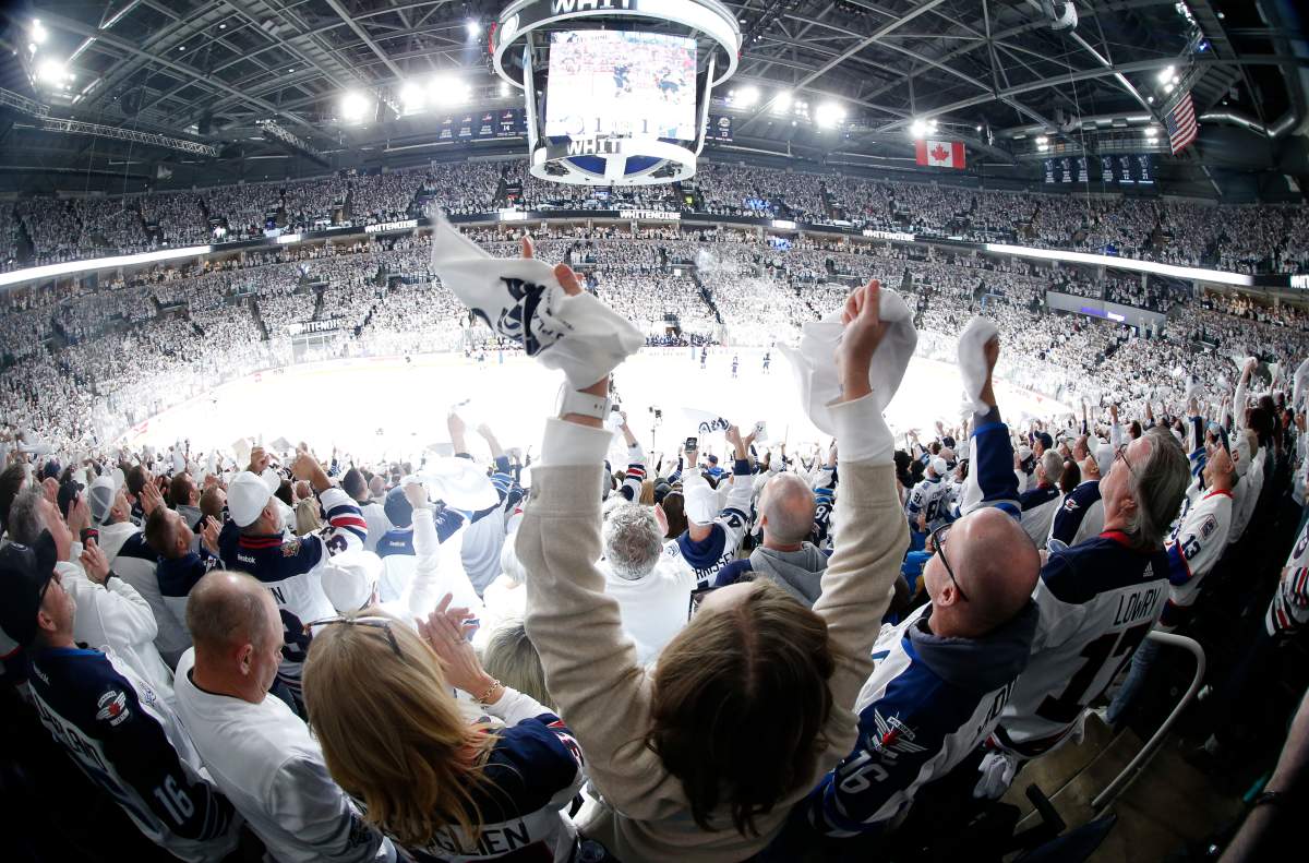 Fans celebrate Winnipeg Jets' Morgan Barron's goal against the St. Louis Blues during first period NHL playoff action in Winnipeg on Saturday, April 19, 2025. THE CANADIAN PRESS/John Woods.