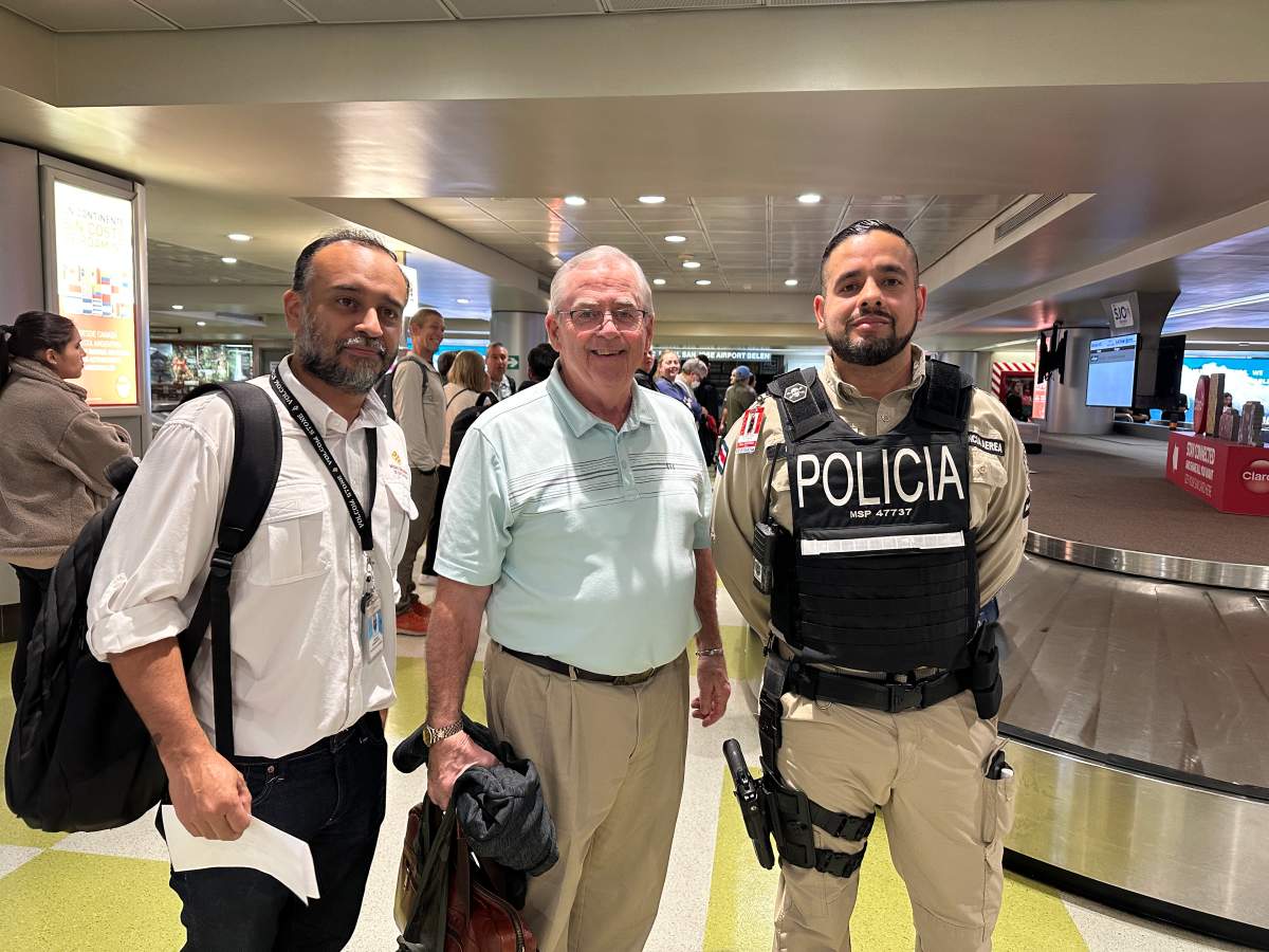 Don McDougall stands with Costa Rican authorities.