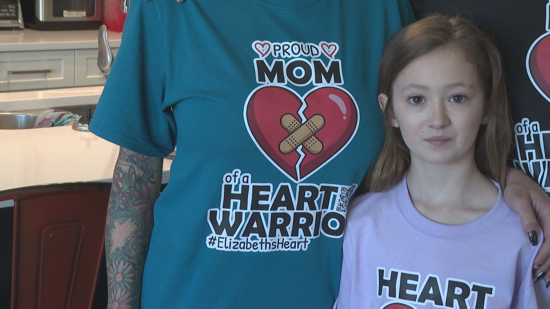A young girl in a heart warrior t-shirt.