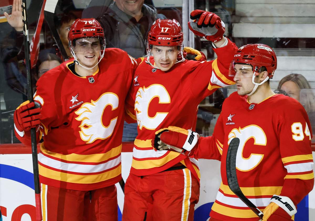 Calgary Flames' Yegor Sharangovich, centre, celebrates his goal with teammates during third period NHL hockey action against the San Jose Sharks in Calgary on Sunday, April 13, 2025.