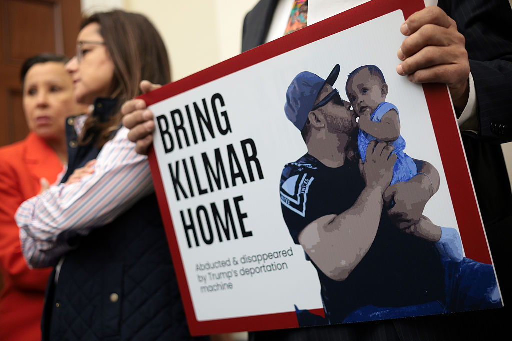 A member of the Congressional Hispanic Caucus holds a picture of Kilmar Abrego Garcia during a news conference to discuss Abrego Garcia's arrest and deportation d at Cannon House Office Building on April 9, 2025 in Washington, DC.