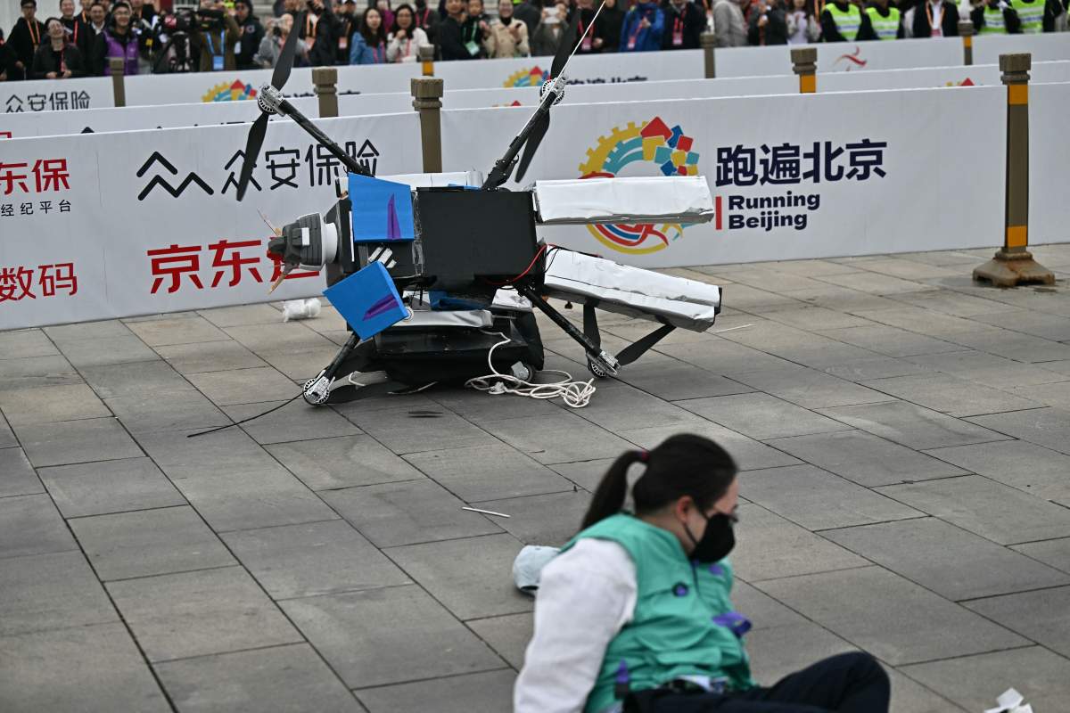 A robot loses control as it takes part in the humanoid robot half marathon in Beijing on April 19, 2025.