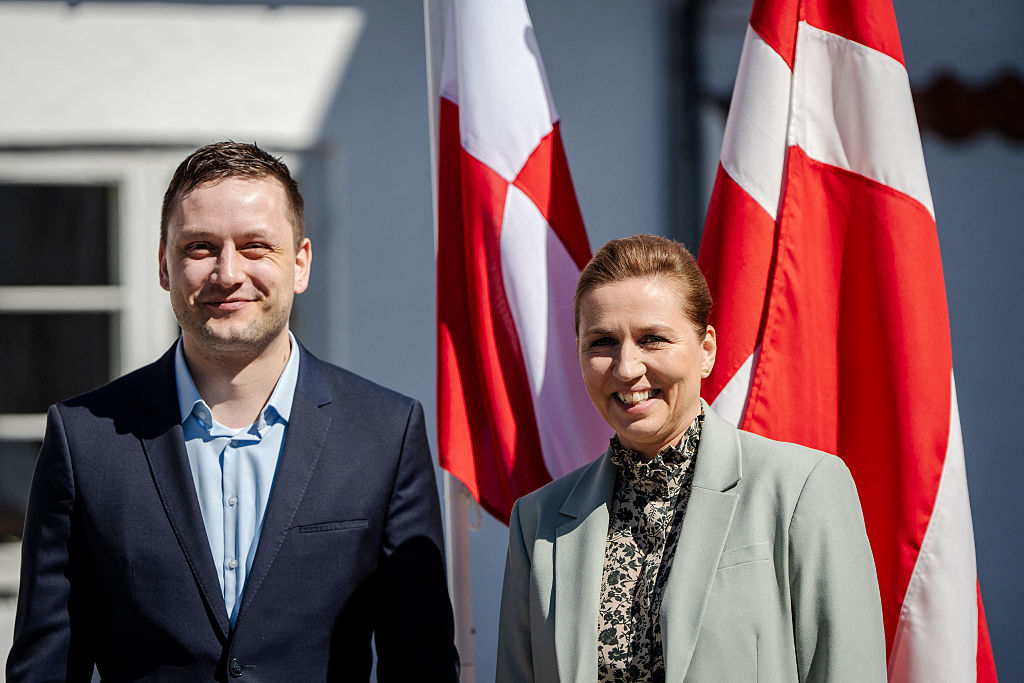 Denmark's Prime Minister Mette Frederiksen (R) and Greenland's Prime Minister Jens-Frederik Nielsen smile for cameras.