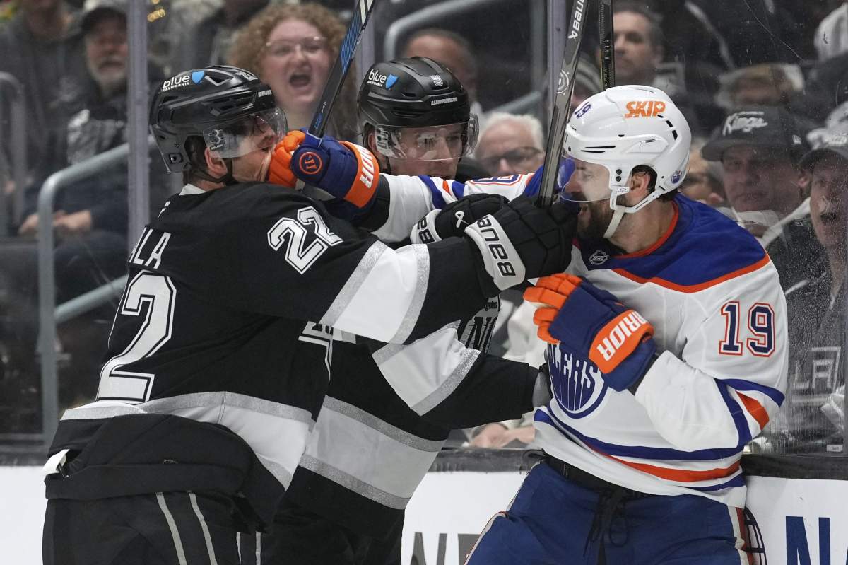 Los Angeles Kings left wing Kevin Fiala, left, and Edmonton Oilers centre Adam Henrique scuffle during the third period in Game 1 of an NHL hockey first-round playoff series Monday, April 21, 2025, in Los Angeles.