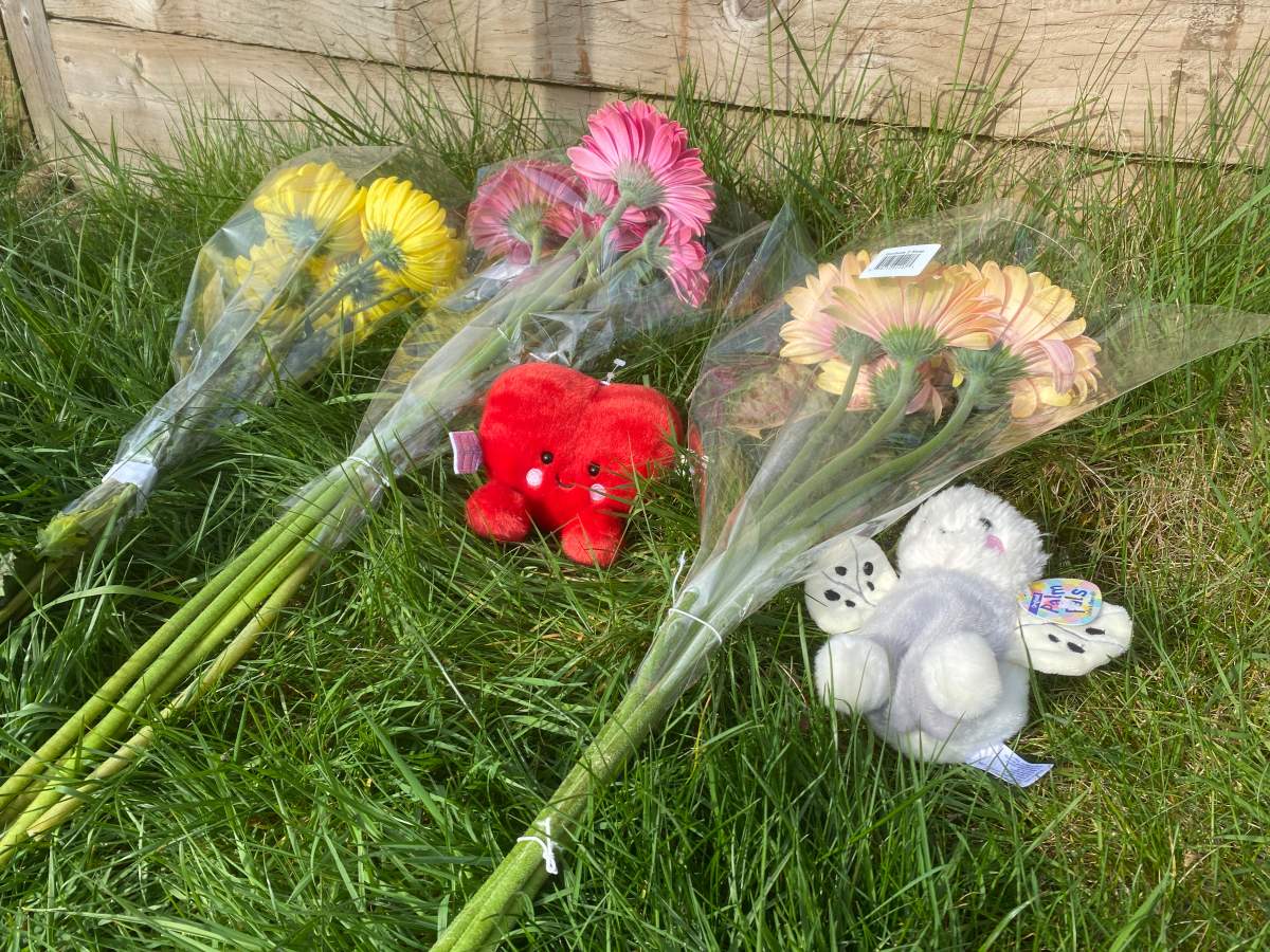 Flowers and stuffies are laid at the scene where a six-year-old girl was killed in a hit-and-run in Surrey on Sunday.