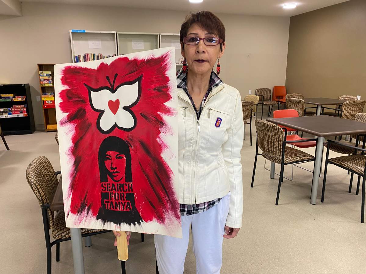 Sue Caribou holds a poster calling for a search for her niece, Tanya Nepinak. 