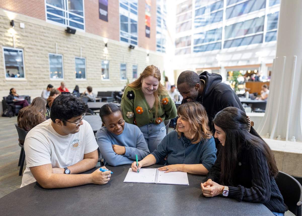 Monica Cojocaru (middle left) leads a project at the University of Guelph which uses AI to detect potential measles outbreaks as cases continue to climb in the area.