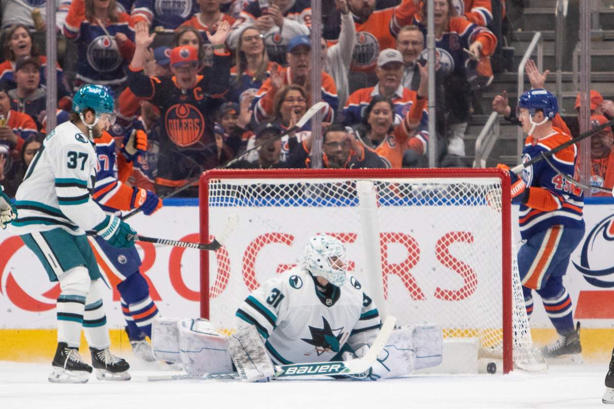 San Jose Sharks' goalie Georgi Romanov (31) is scored on by Edmonton Oilers' Ty Emberson (49) as Connor McDavid (97) and Timothy Liljegren (37) look on during first period NHL action in Edmonton on Friday, April 11, 2025.